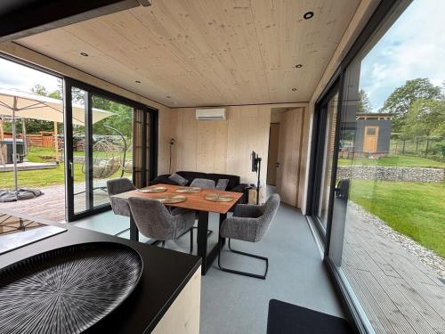 a kitchen and dining room of a house with a table and chairs at Chalet WaldZeit in Weiskirchen