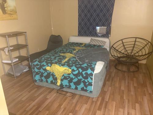 a small bedroom with a bed with a bedspread on it at Pixie hollow single vacation retreat resort dwelling in Orlando