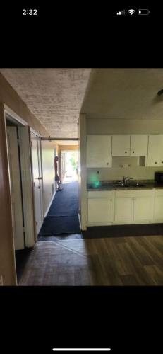 an empty room with a kitchen and a hallway at Pixie hollow single vacation retreat resort dwelling in Orlando