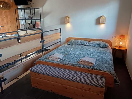 a bedroom with a bed with a wooden frame at Chalet Nest in Gravedona