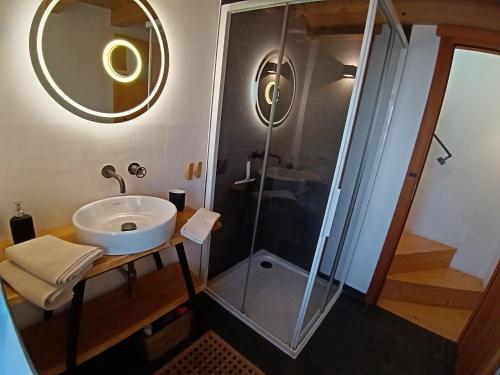 a bathroom with a sink and a shower at Chalet Nest in Gravedona