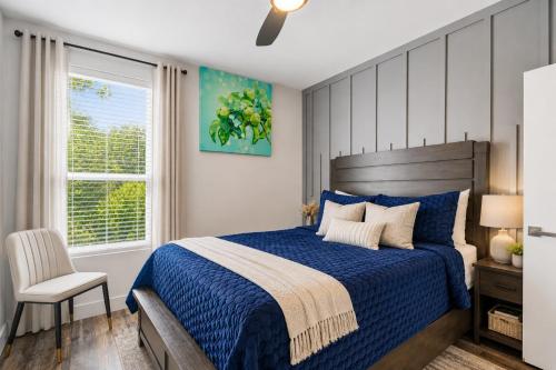 a bedroom with a blue bed and a chair at The Ultimate View House in Dallas