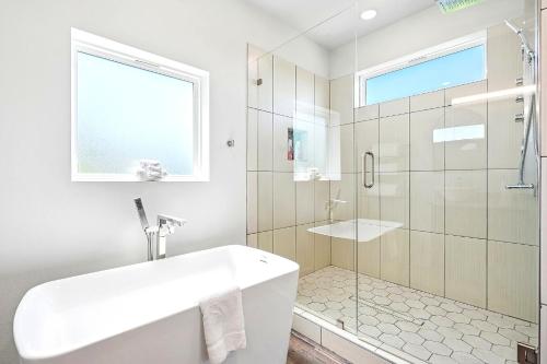 a white bathroom with a shower and a sink at The Ultimate View House in Dallas