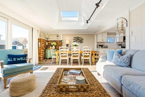 a living room with a couch and a table at Mimi's Beach House Beach Access in Wells