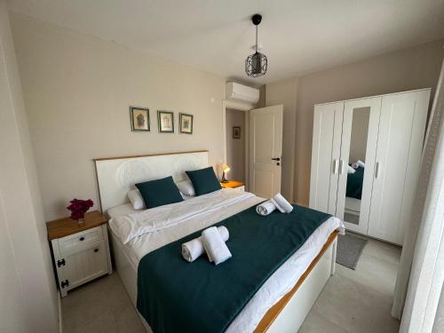 a bedroom with a bed with two pillows on it at Olea Alacati in Çeşme