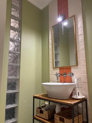 a bathroom with a sink and a mirror at Jurmala Cozy Vibes - self check in in Jūrmala