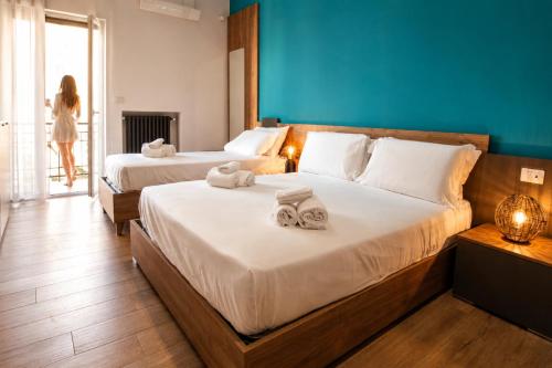 a hotel room with two beds with towels on them at Dadà - Luxury Suite in Bari