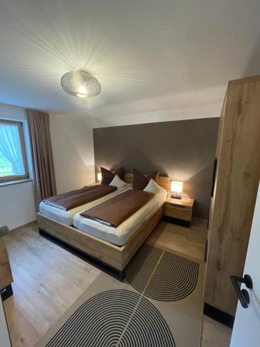 a bedroom with two beds in a room at Ferienhotel Barmsee in Krün