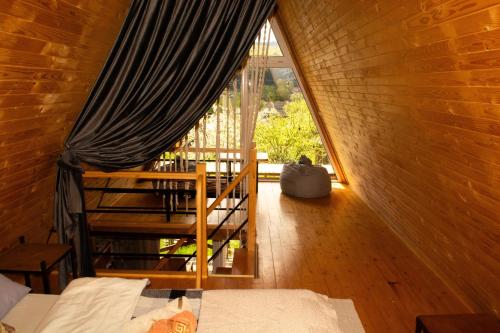 a room with a large window in a cabin at Sadyba Lileya in Verkhovyna