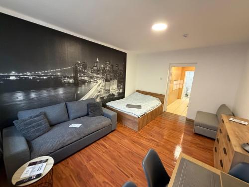 a living room with a couch and a bed at ApartmentsByMatyrafa-XVI in Tarnowskie Góry
