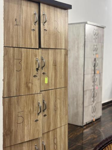 a group of wooden lockers in a room at Manavi Hostel Near by Mathura Railway Station in Mathura