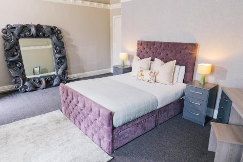 a bedroom with a large bed and a mirror at Mitre Hotel Manchester City Centre in Manchester