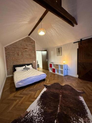 a bedroom with a bed and a brick wall at Cismigiu Apartments in Bucharest