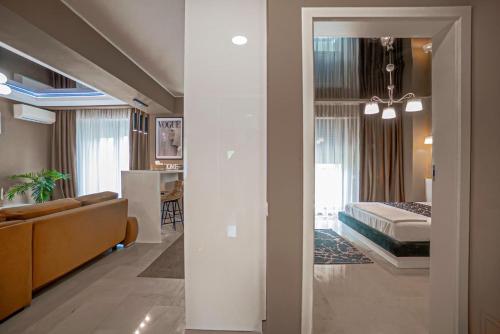 a hotel room with a bed and a living room at Sas 1 Luxury Apartments in Mamaia