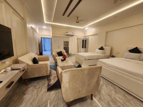a hotel room with a bed and a living room at Pc Inn Executive Class Hotel in Sukkur