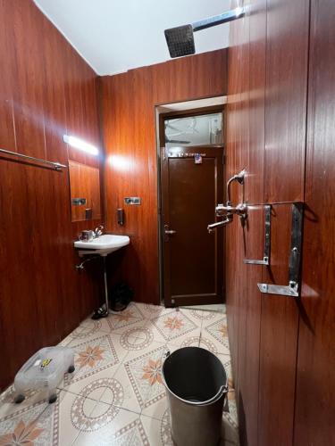 a bathroom with a toilet and a sink at Vedic Dham Ganga in Rishīkesh