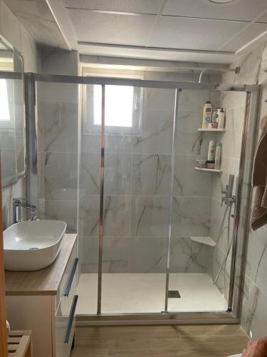 a shower with a glass door in a bathroom at Mediterranean Apartment with WIFI in Canet de Berenguer