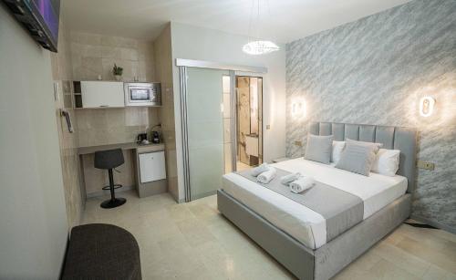 a bedroom with a large bed and a bathroom at Casa Luxore in Alicante