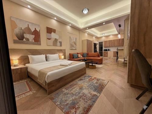 a bedroom with a large bed and a living room at Ya Bayté in Beirut