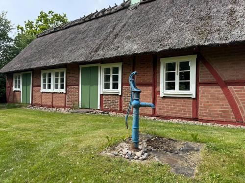a water fountain in front of a house at Haqvins stuga in Förslöv
