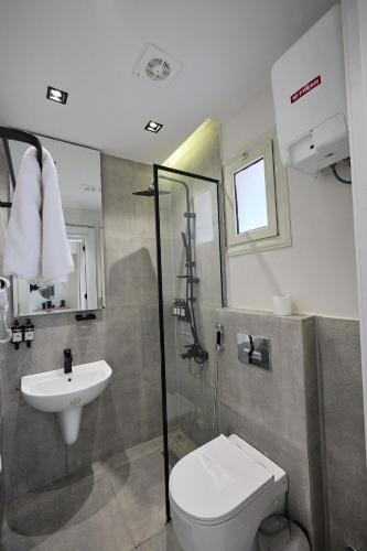 a bathroom with a sink and a toilet and a shower at Settle inn Fajr Boutique hotel in Cairo