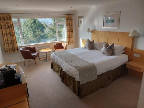 a hotel room with a large bed and a window at Lingwood Lodge in Bowness-on-Windermere