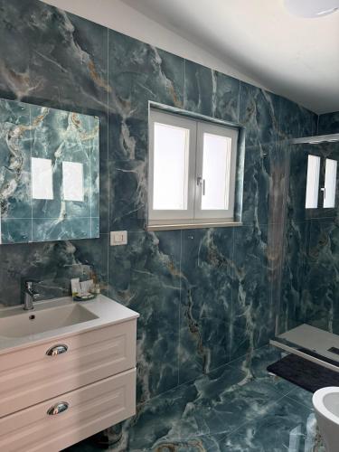 a bathroom with a sink and a mirror at B&B Aura in Pontecagnano