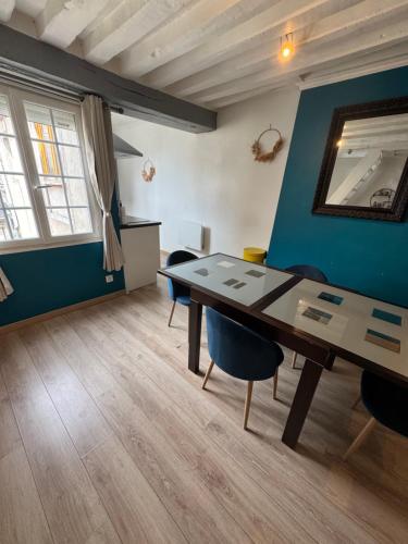 a dining room with a table and chairs at Glycine in Orléans