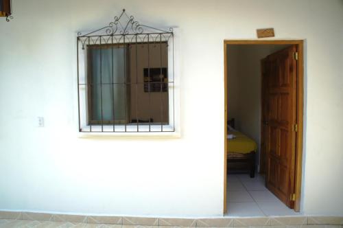 a mirror on the side of a white wall at Hostal Casa San Miguel in Masaya