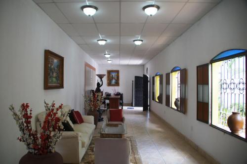 a living room with a couch and some windows at Hostal Casa San Miguel in Masaya