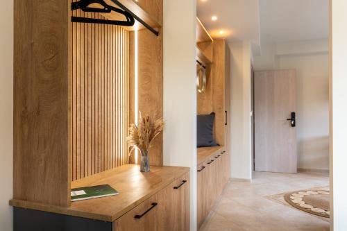 a home office with a wooden desk in a hallway at Pnoes Suites Apartments in Skiathos