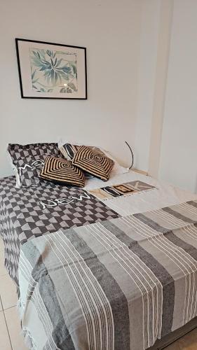 a bed with two pillows on it in a bedroom at L'Interlude in Saint-Denis