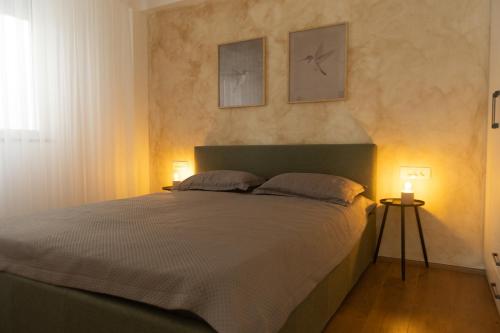 a bedroom with a bed with two pictures on the wall at Bitola Stay in Bitola