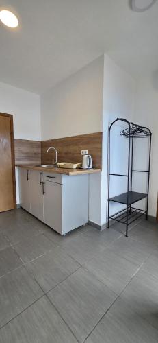 a kitchen with a counter and a sink and a shelf at Ankica & Anamarija Apartments in Neum