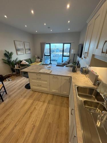 a kitchen and living room with a counter top at Blackhill Lookout in Portrush
