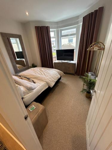 a bedroom with a bed and a large window at Blackhill Lookout in Portrush