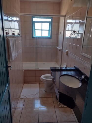 a bathroom with a sink and a toilet at hotel castelo in Cidreira