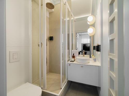 a bathroom with a shower and a toilet and a sink at Marszałkowska Luxury Apartments by Sofija in Warsaw