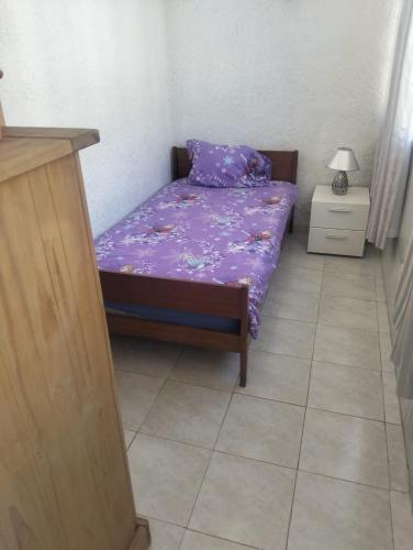 a small bed with purple sheets in a room at Siroco Nau Algarve in Olhão