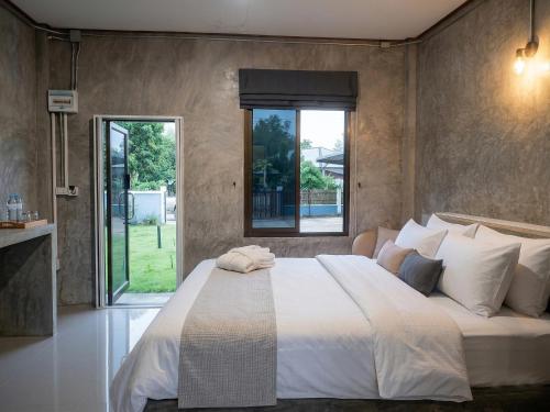 a bedroom with a large bed and a large window at View Doi Resort in Ban Mai Thung Mot