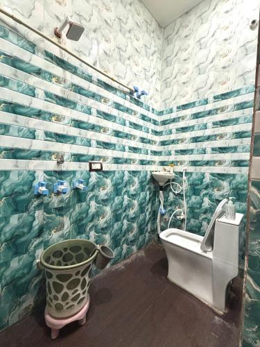 a bathroom with a fish mural on the wall at Manavi Hostel Near by Mathura Railway Station in Mathura