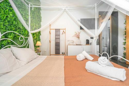 a bedroom with a large bed with towels on it at Elite Apartment SPA in Catania