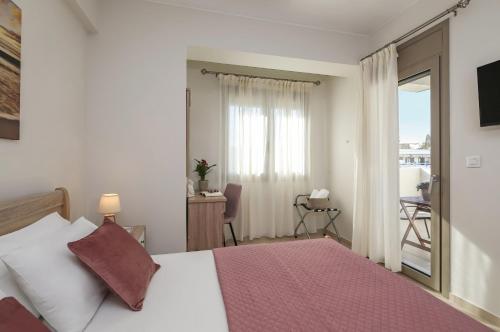 a hotel room with a bed and a balcony at Galanthus Apartment 2 in Chania