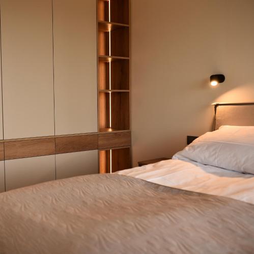 a bedroom with two beds and a closet at Szept Lasu in Żabiczyn