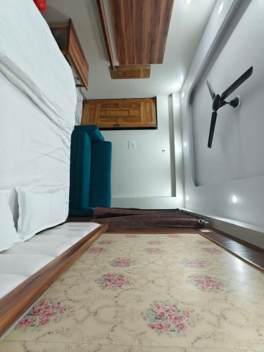 a room with a bed with a rug and a ceiling at Hotel Blue Neck in Patna