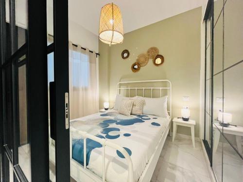 a bedroom with a white bed and a glass door at Cana Rock in Punta Cana