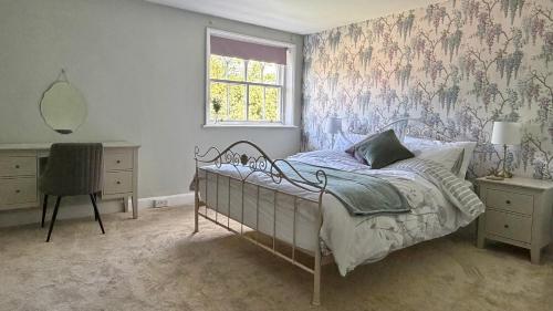 a bedroom with a bed with a floral wallpaper at Bleasby Hall - Kelham Suite B&B in Bleasby
