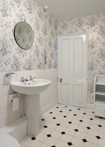a white bathroom with a sink and a mirror at Bleasby Hall - Kelham Suite B&B in Bleasby