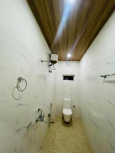 a bathroom with a toilet in a room at Hotel STAYVILLA in Guwahati