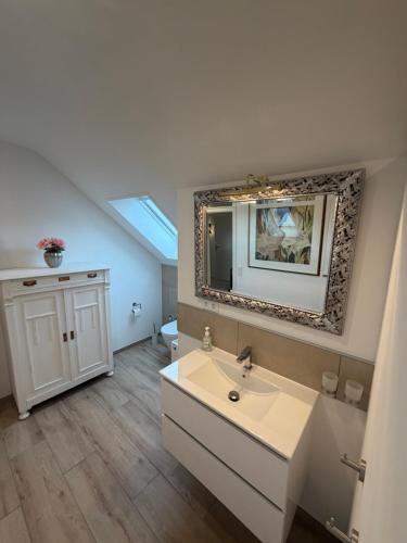 a bathroom with a sink and a mirror at Panorama-Blick Brüggen in Brüggen